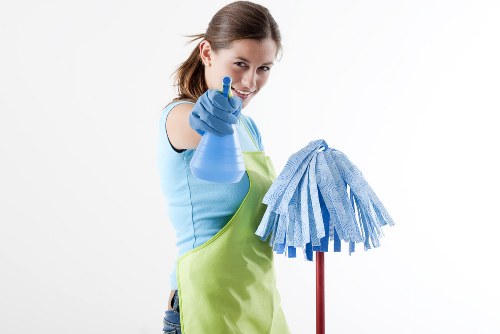 Domestic cleaner preparing a tidy Waterloo apartment living room